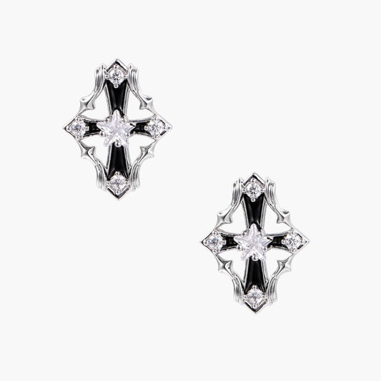 Pair of Art Deco-style stud earrings with star crystals, black enamel accents, and white gold plating on ivory background.