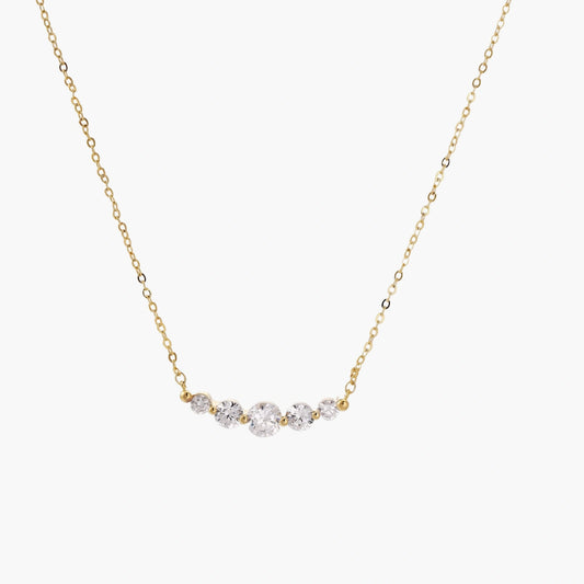 Delicate 14K gold-plated necklace with five graduated zirconia stones arranged in a curved arc on fine chain